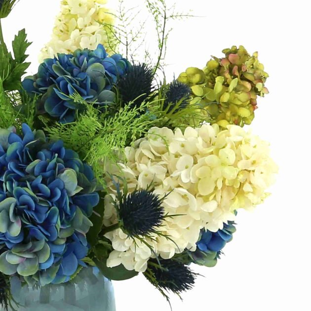 Assorted Hydrangea, Thistle and Fern Floral Arrangement in Colored Glass Vase - Image 4